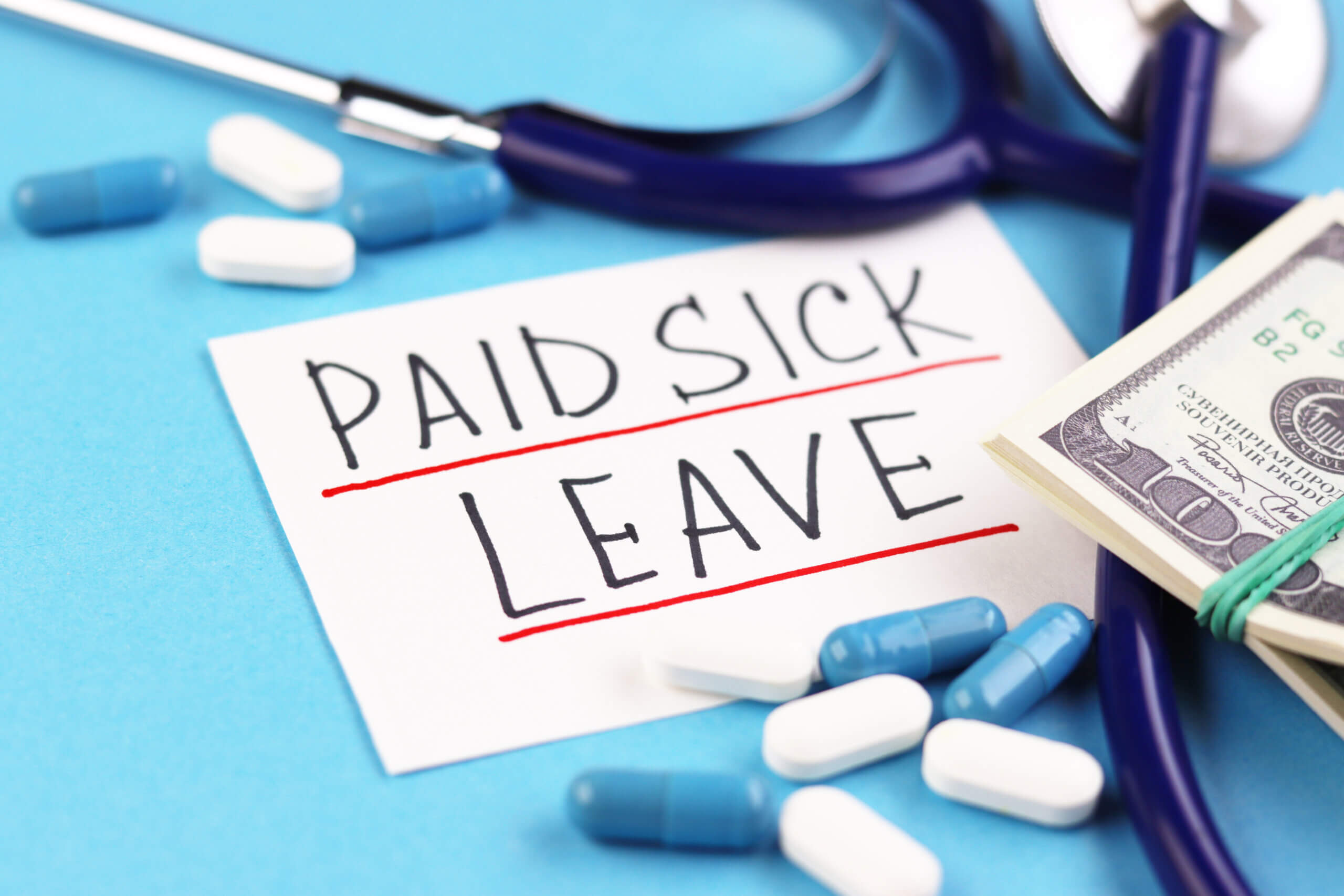 text paid sick leave and money with pills on a blue background