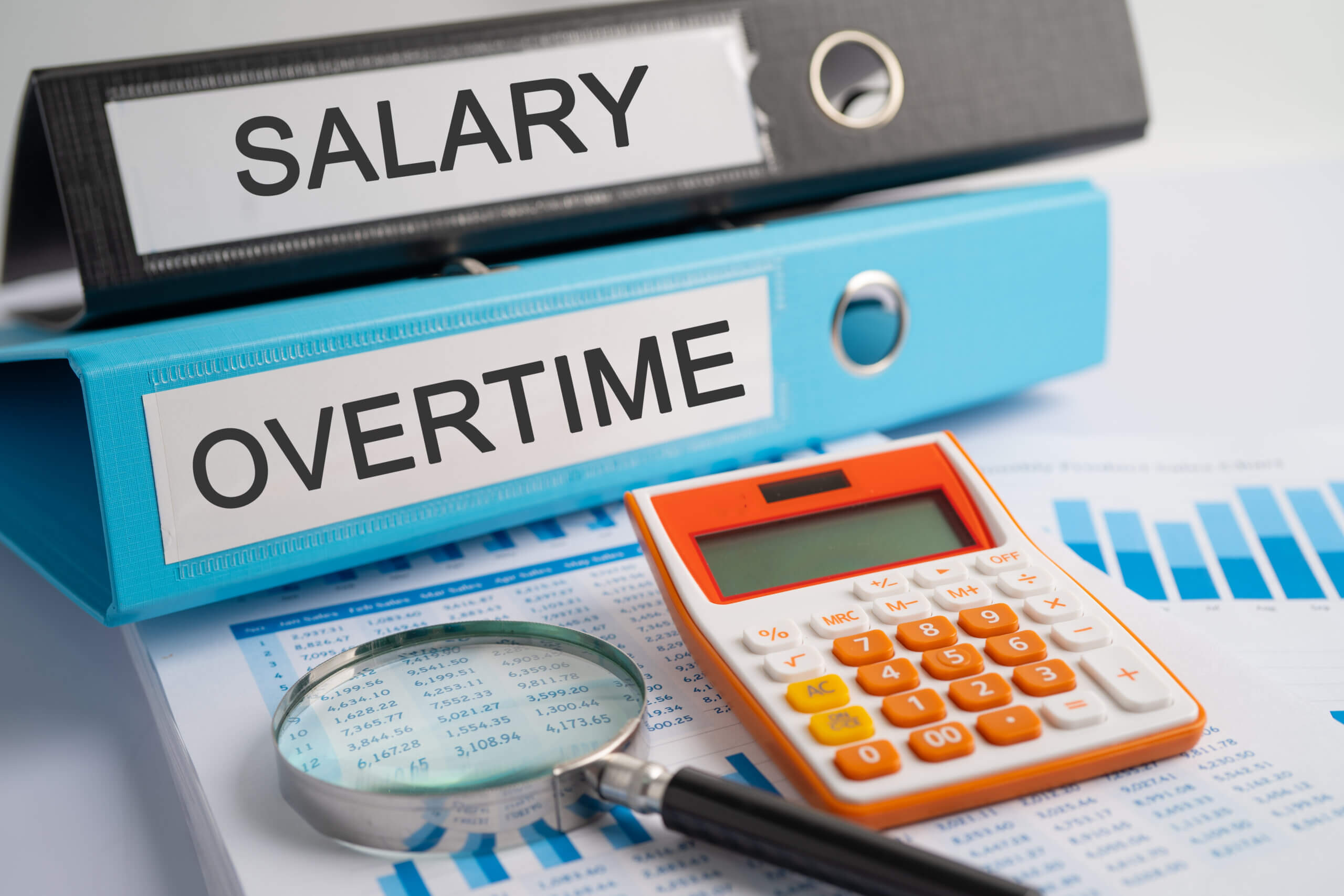 Salary, Overtime. Binder data finance report business with graph analysis in office.